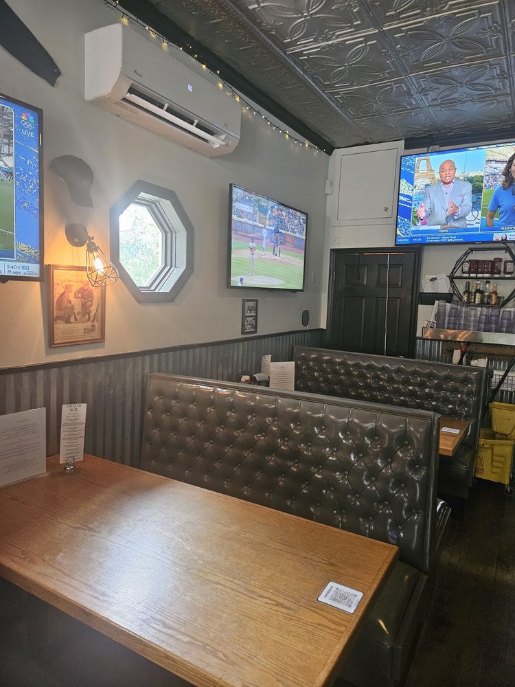 Tufted booths and big-screen TVs showing the game in the dining room